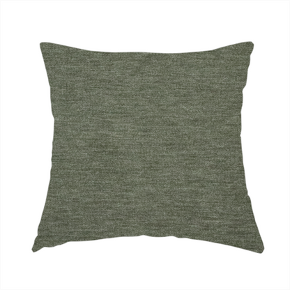 The fabric used to create this handmade cushion is a solid sage green woven fabric swatch with a fine, subtle texture.
