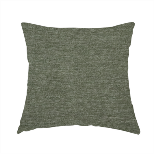 The fabric used to create this handmade cushion is a solid sage green woven fabric swatch with a fine, subtle texture.