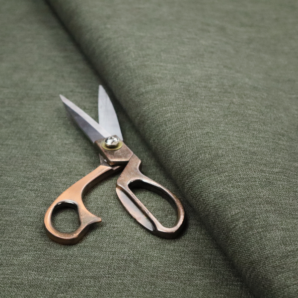A solid sage green woven fabric swatch with a fine, subtle texture.
