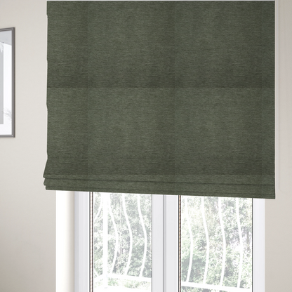 The fabric used to create these Roman blinds is a solid sage green woven fabric swatch with a fine, subtle texture.