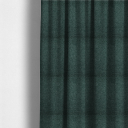 The fabric used to create these made-to-measure curtains is a solid teal or deep turquoise woven textile with a fine, subtle textured weave.