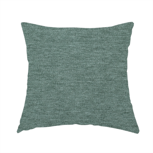 The fabric used to create this handmade cushion is a solid light teal or seafoam green woven textile with a fine, subtle textured weave.