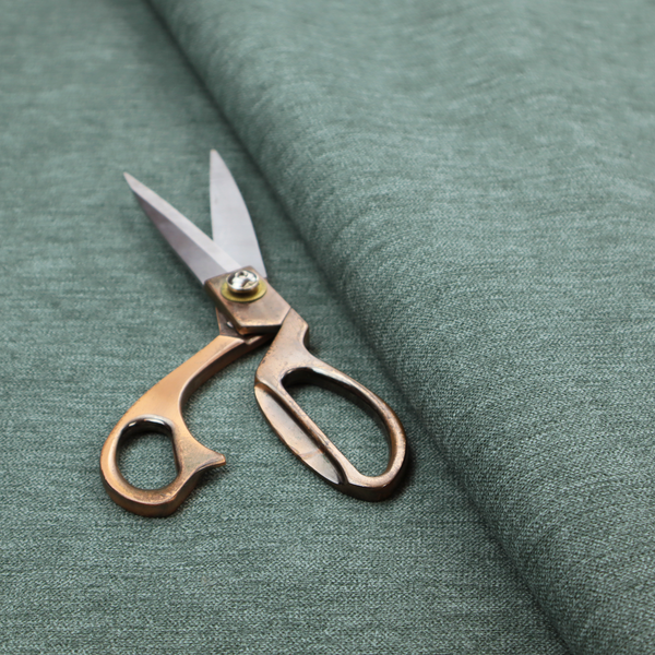 A solid light teal or seafoam green woven textile with a fine, subtle textured weave.