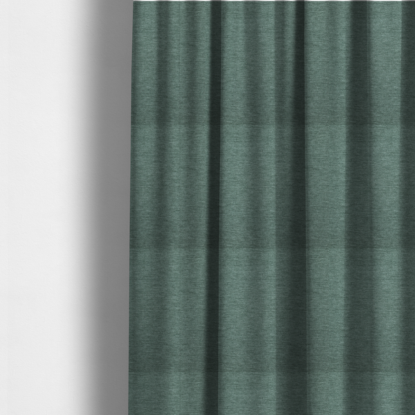 the fabric used to create these made-to-measure curtains is a solid light teal or seafoam green woven textile with a fine, subtle textured weave.
