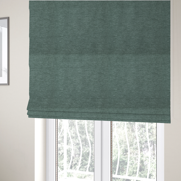 The fabric used to create these Roman blinds is a solid light teal or seafoam green woven textile with a fine, subtle textured weave.