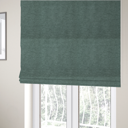The fabric used to create these Roman blinds is a solid light teal or seafoam green woven textile with a fine, subtle textured weave.
