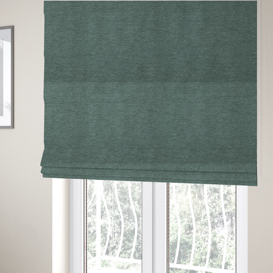The fabric used to create these Roman blinds is a solid light teal or seafoam green woven textile with a fine, subtle textured weave.