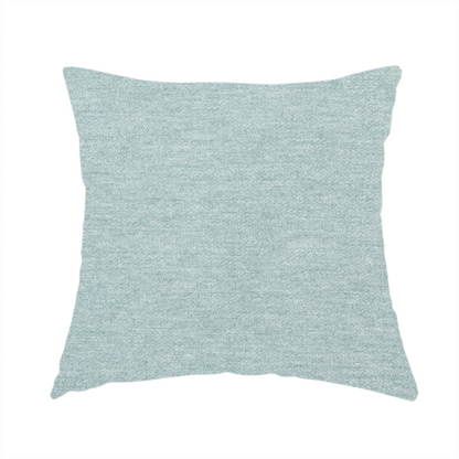 The fabric used to create this handmade cushion is a solid pale aqua or mint green woven textile with a fine, subtle textured weave.