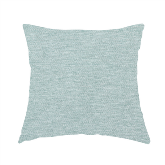 The fabric used to create this handmade cushion is a solid pale aqua or mint green woven textile with a fine, subtle textured weave.