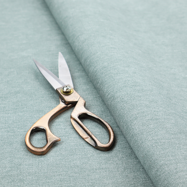 A solid pale aqua or mint green woven textile with a fine, subtle textured weave.