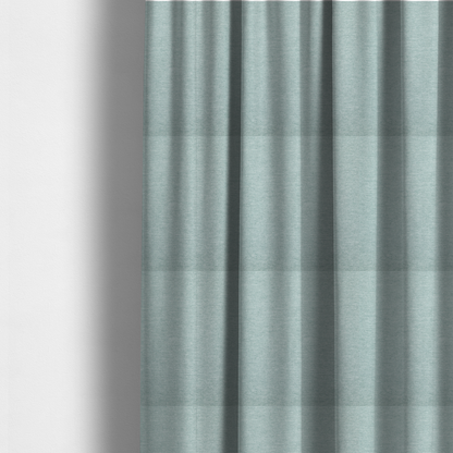 The fabric used to create these made-to-measure curtains is a solid pale aqua or mint green woven textile with a fine, subtle textured weave.