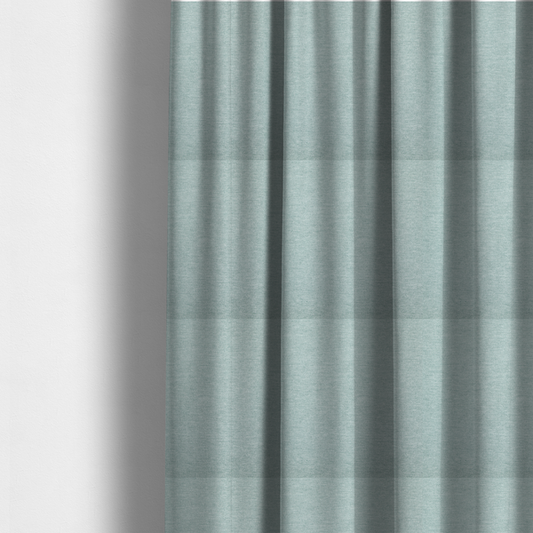 The fabric used to create these made-to-measure curtains is a solid pale aqua or mint green woven textile with a fine, subtle textured weave.