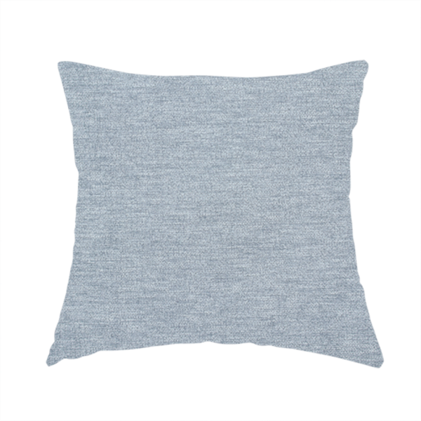The fabric used to create this handmade cushion is a solid light periwinkle woven fabric swatch with a fine, subtle texture.