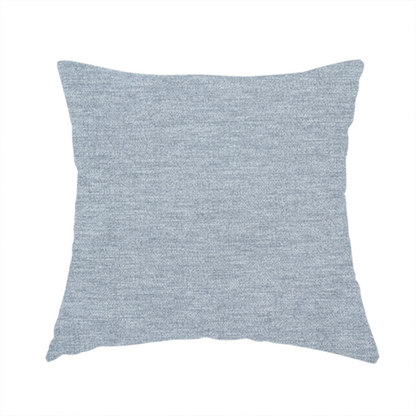 The fabric used to create this handmade cushion is a solid light periwinkle woven fabric swatch with a fine, subtle texture.