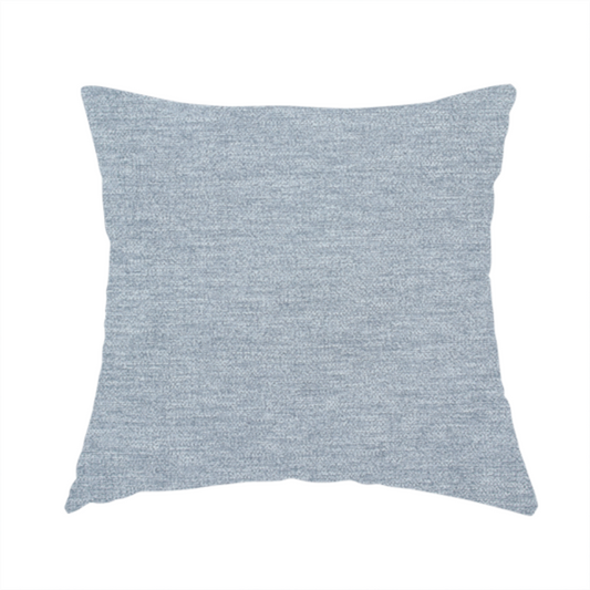 The fabric used to create this handmade cushion is a solid light periwinkle woven fabric swatch with a fine, subtle texture.