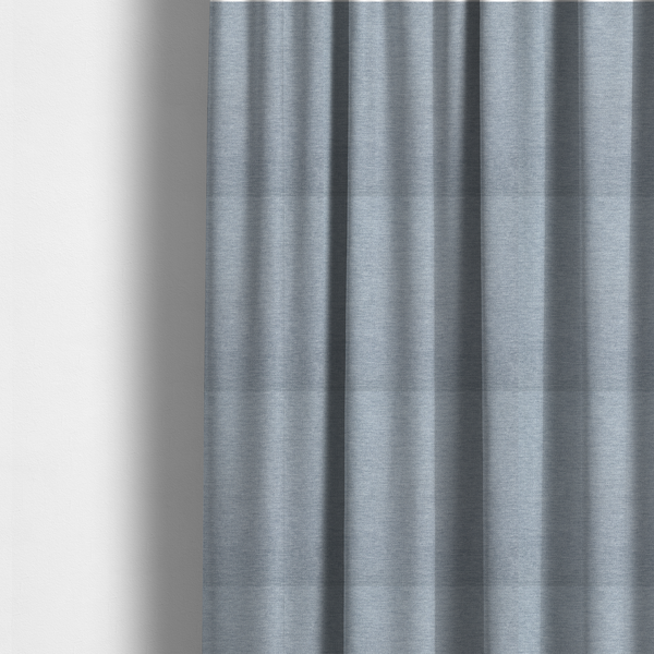 The fabric used to create these made-to-measure curtains is a solid light periwinkle woven fabric swatch with a fine, subtle texture.