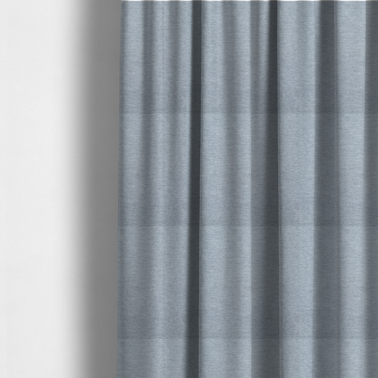 The fabric used to create these made-to-measure curtains is a solid light periwinkle woven fabric swatch with a fine, subtle texture.