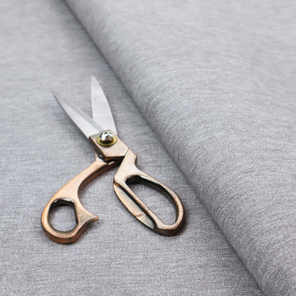 A medium grey or silver-grey woven textile with a fine, subtle textured weave.