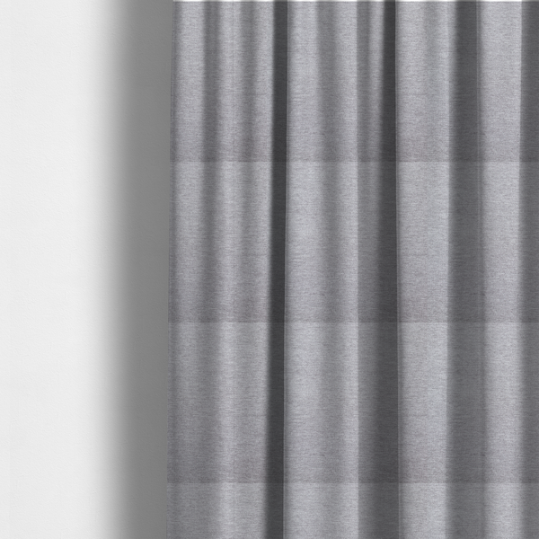 The fabric used to create these made-to-measure curtains is a medium grey or silver-grey woven textile with a fine, subtle textured weave.