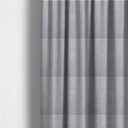 The fabric used to create these made-to-measure curtains is a medium grey or silver-grey woven textile with a fine, subtle textured weave.