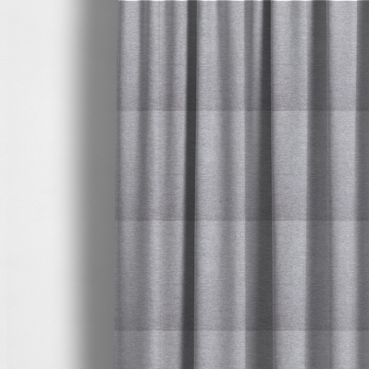 The fabric used to create these made-to-measure curtains is a medium grey or silver-grey woven textile with a fine, subtle textured weave.