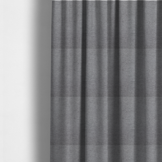 The fabric used to create these made-to-measure curtains is a solid dark grey or charcoal woven textile with a fine, subtle textured weave.