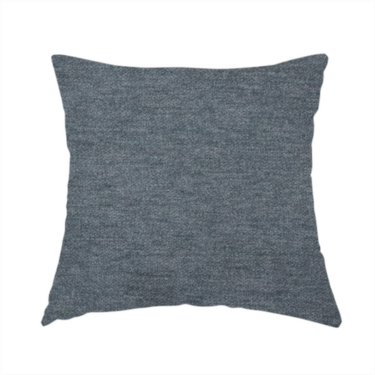 The fabric used to create this handmade cushion is a solid dark denim blue or slate blue woven textile with a fine, subtle textured weave.