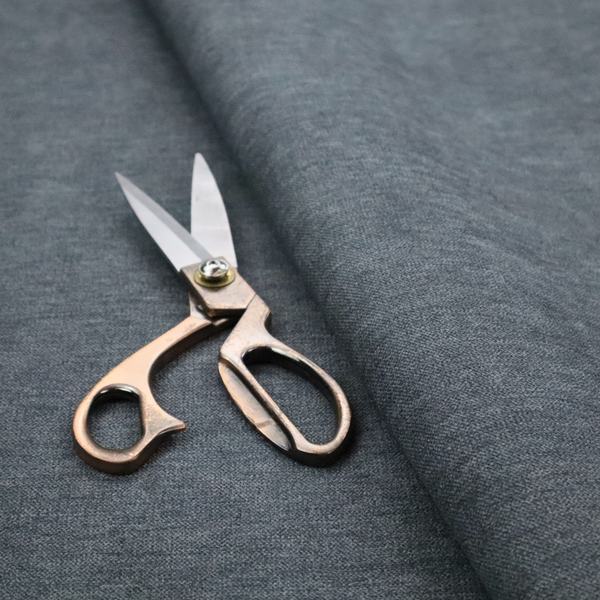 A solid dark denim blue or slate blue woven textile with a fine, subtle textured weave.