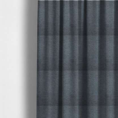 The fabric used to create these made-to-measure curtains is a solid dark denim blue or slate blue woven textile with a fine, subtle textured weave.