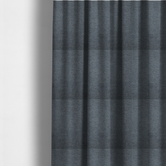 The fabric used to create these made-to-measure curtains is a solid dark denim blue or slate blue woven textile with a fine, subtle textured weave.
