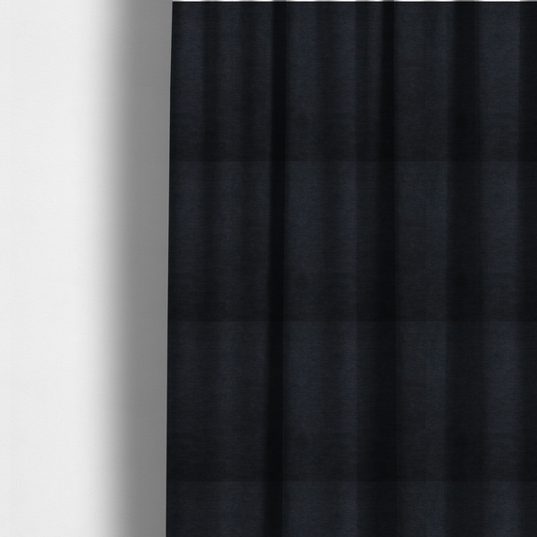 The fabric used to create these made-to-measure curtains is a solid dark charcoal or near-black woven textile with a fine, subtle textured weave.