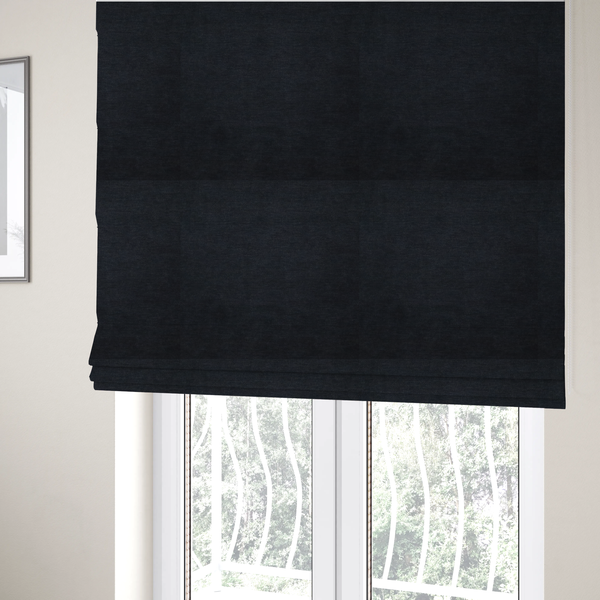 The fabric used to create these Roman blinds is a solid dark charcoal or near-black woven textile with a fine, subtle textured weave.