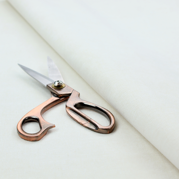 A light grey or off-white fabric with a tight, fine weave texture.