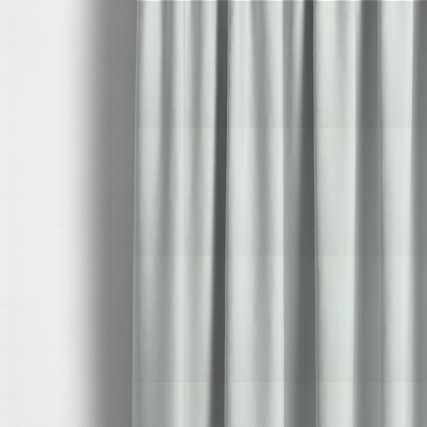 The fabric used to create these made-to-measure curtains is a light grey or off-white fabric with a tight, fine weave texture.