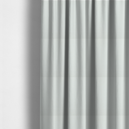 The fabric used to create these made-to-measure curtains is a light grey or off-white fabric with a tight, fine weave texture.