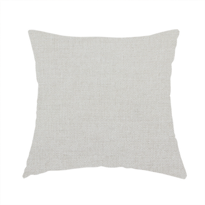 The fabric used to create this handmade cushion is a textured, light beige or cream-coloured woven upholstery fabric.