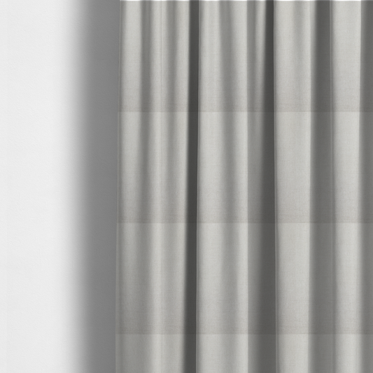The fabric used to create these made-to-measure curtains is a textured, light beige or cream-coloured woven upholstery fabric.