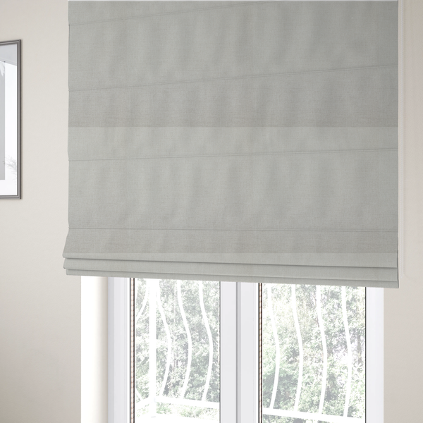 The fabric used to create these Roman blinds is a textured, light beige or cream-coloured woven upholstery fabric.
