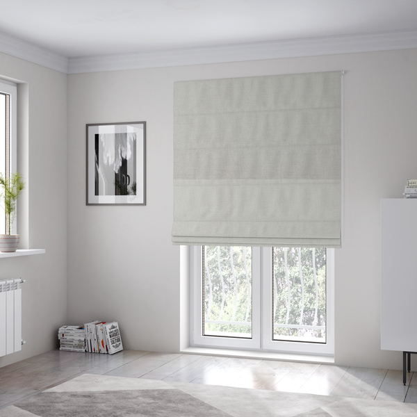 The fabric used to create these Roman blinds is a textured, light beige or cream-coloured woven upholstery fabric.