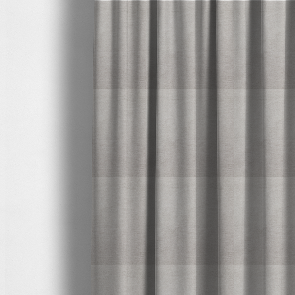 The fabric used to create these made-to-measure curtains is a textured, light taupe or greyish-beige woven upholstery fabric.