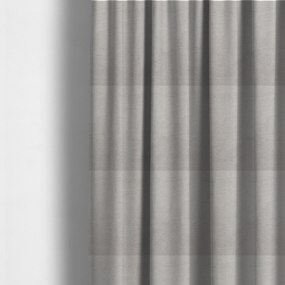 The fabric used to create these made-to-measure curtains is a textured, light taupe or greyish-beige woven upholstery fabric.