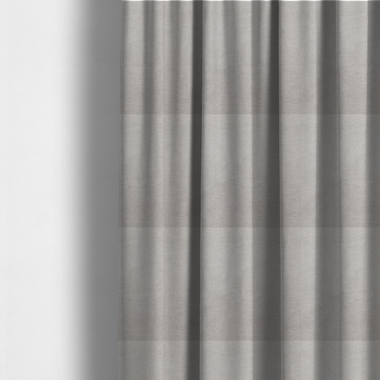 The fabric used to create these made-to-measure curtains is a textured, light taupe or greyish-beige woven upholstery fabric.