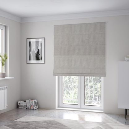 The fabric used to create these Roman blinds is a textured, light taupe or greyish-beige woven upholstery fabric.