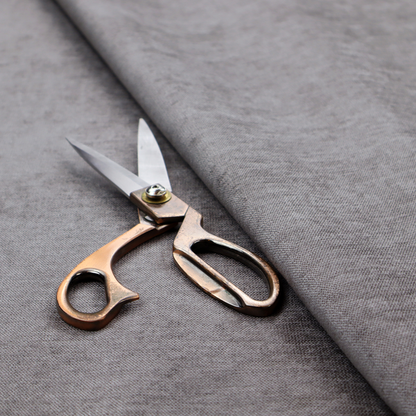 A textured, medium grey woven upholstery fabric.