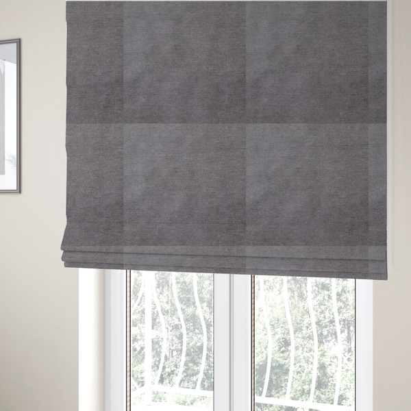 The fabric used to create these Roman blinds is a textured, medium grey woven upholstery fabric.