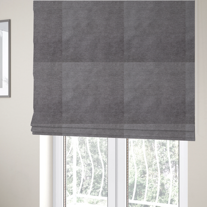 The fabric used to create these Roman blinds is a textured, medium grey woven upholstery fabric.