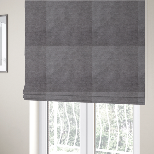 The fabric used to create these Roman blinds is a textured, medium grey woven upholstery fabric.