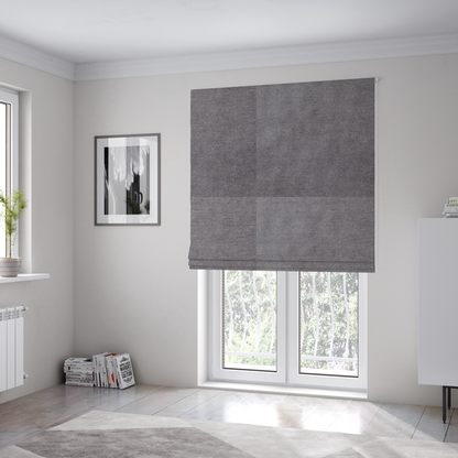 The fabric used to create these Roman blinds is a textured, medium grey woven upholstery fabric.