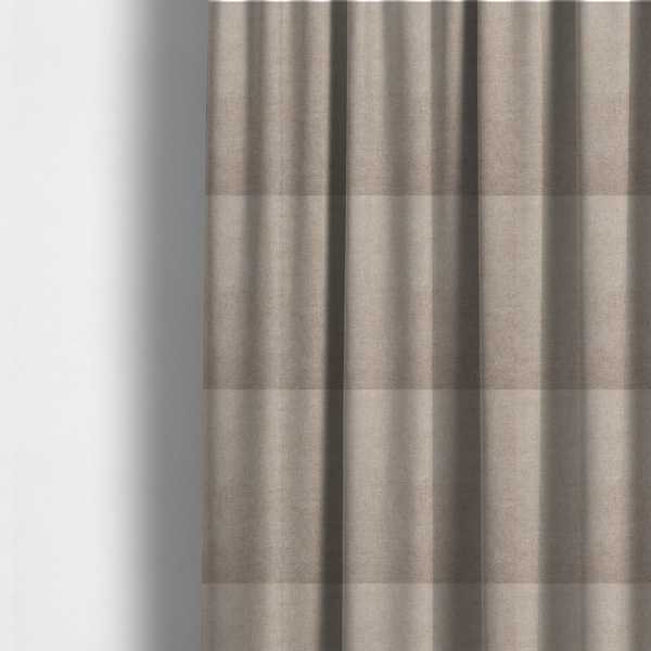 The fabric used to create these made-to-measure curtains is a textured, warm taupe or tan woven upholstery fabric.