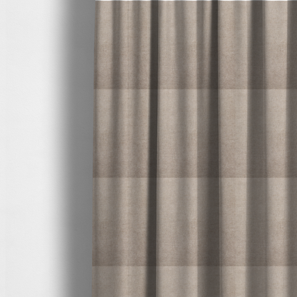 The fabric used to create these made-to-measure curtains is a textured, warm taupe or tan woven upholstery fabric.